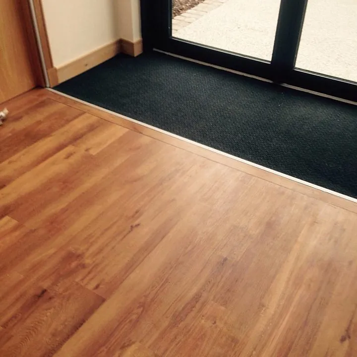 Wooden flooring and entrance carpet