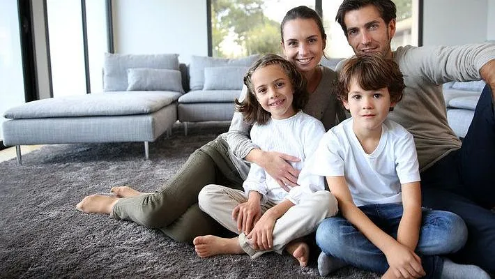 A family sitting together on their new carpet